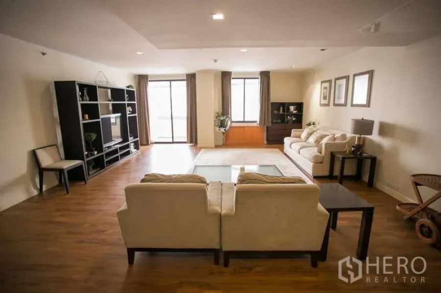 Condominium for rent or sale in Watthana, Bangkok - Another angle of the bright living room with balcony access and shelving.