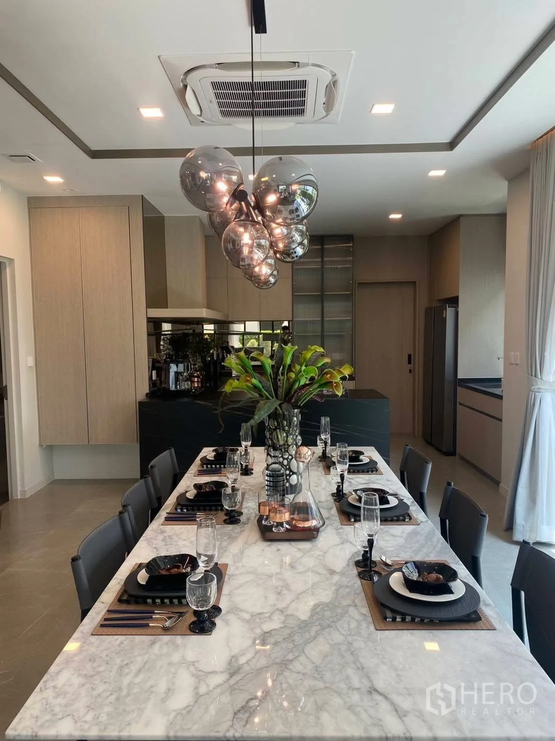 Detached House for rent or sale in Bang Phli, Samut Prakan - Dining area with a long marble table and cluster pendant lights.