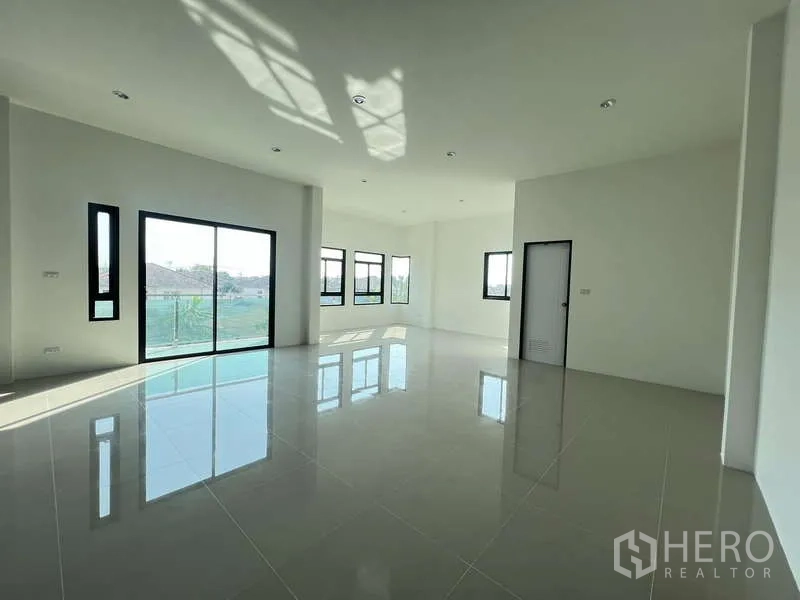Warehouse for rent or sale - Sunlit office zone with windows on two sides and glossy tiles.