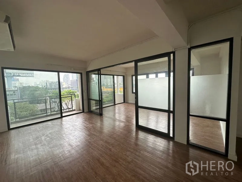 Office Space for rent in Sathon, Bangkok - Bright open-plan office with wood floors, glass partitions and a balcony with city views in Sathon.