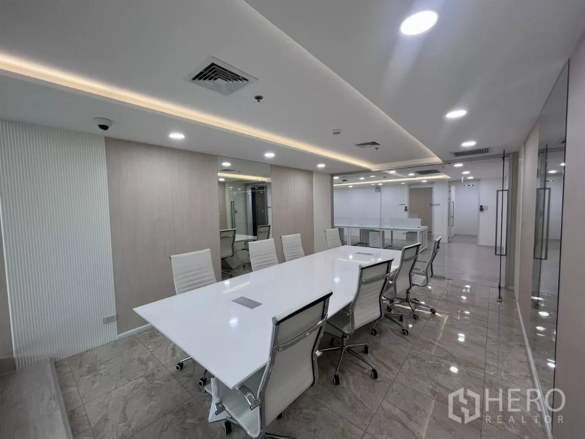 Office Space for rent in Din Daeng, Bangkok - Conference room with white table, swivel chairs and glazed partitions facing the open office.