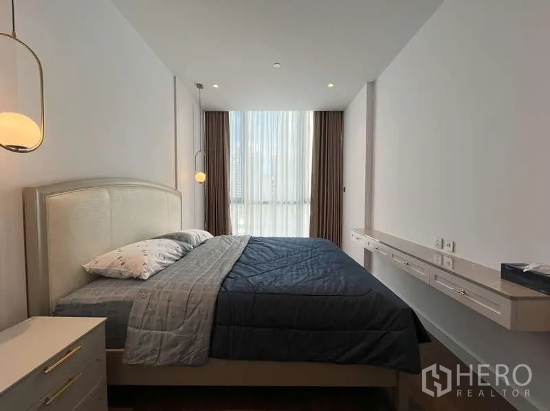 Condominium for rent or sale in Sathon, Bangkok - Master bedroom facing a full-height window with blackout curtains.