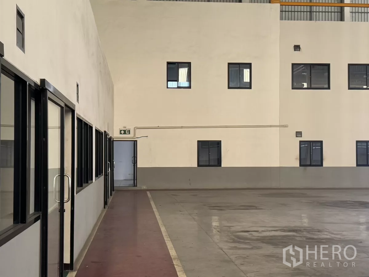 Factory for rent or sale in Bang Phli, Samut Prakan - Glass-front office corridor along the production floor.