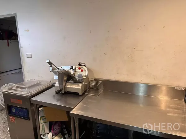 Retail Space for rent in Watthana, Bangkok - Commercial prep room with stainless-steel worktops and a deli slicer.