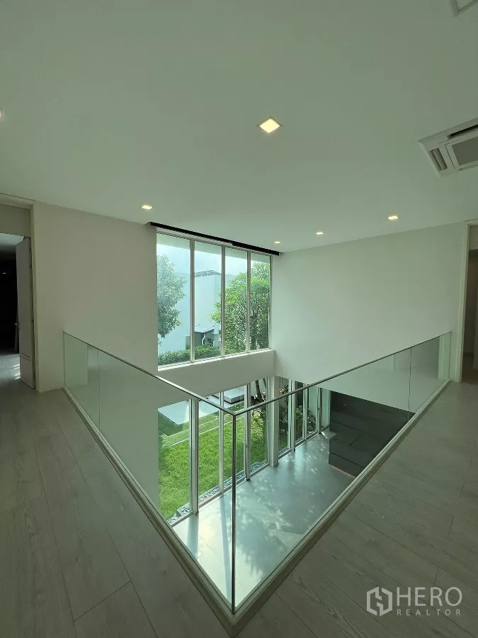 Detached House for sale in Bang Phli, Samut Prakan - Upper landing with glass balustrade overlooking the green courtyard