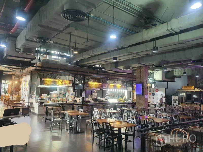 零售空间 出租在Khlong Toei, Bangkok - 工业风美食广场式室内，挑高天花与裸露风管，吊灯与多排餐桌，位于曼谷澎蓬商圈。