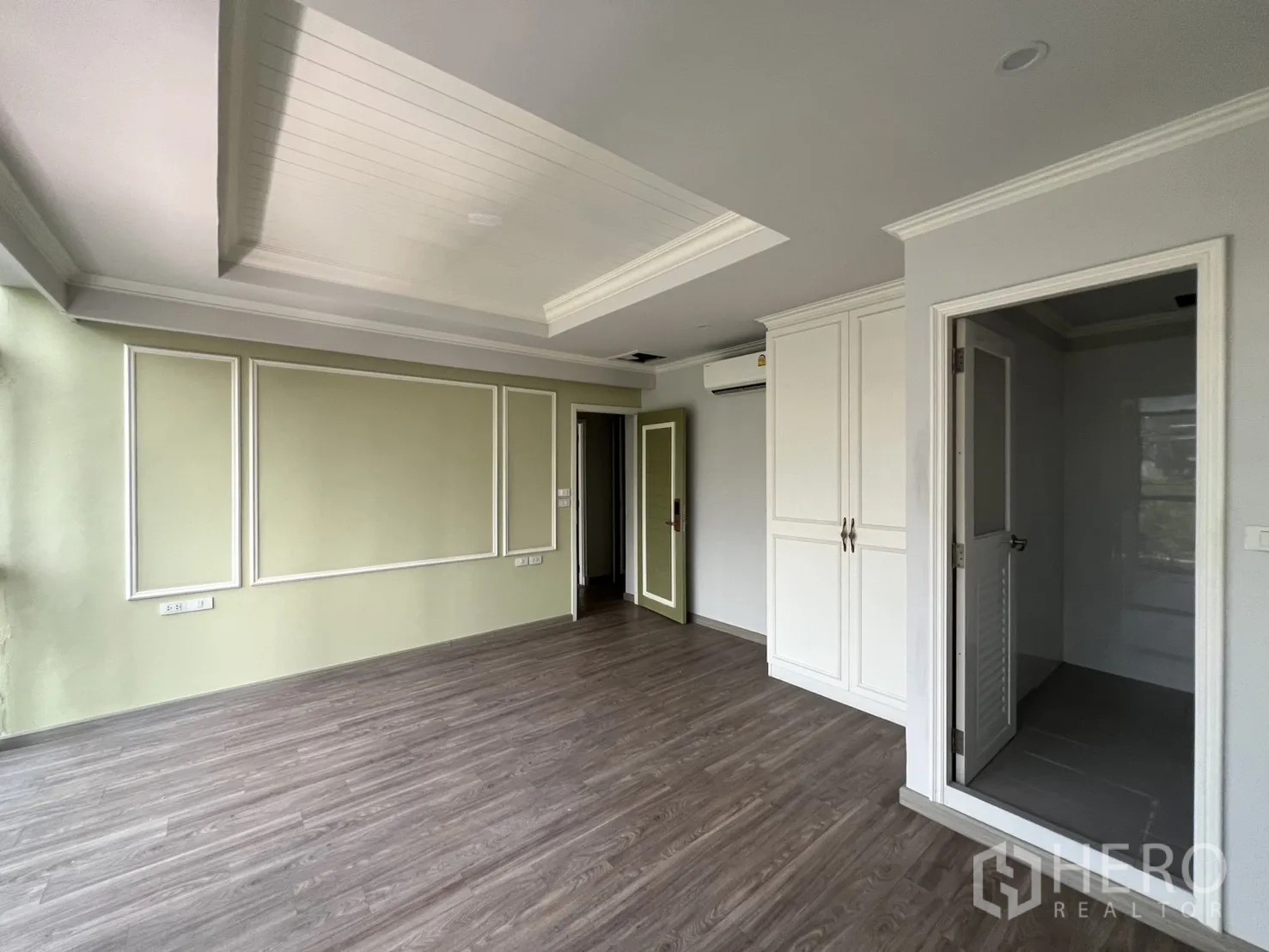 Shophouse for rent in Bang Rak, Bangkok - Sunlit room with decorative wall trim, wood flooring and ensuite access.