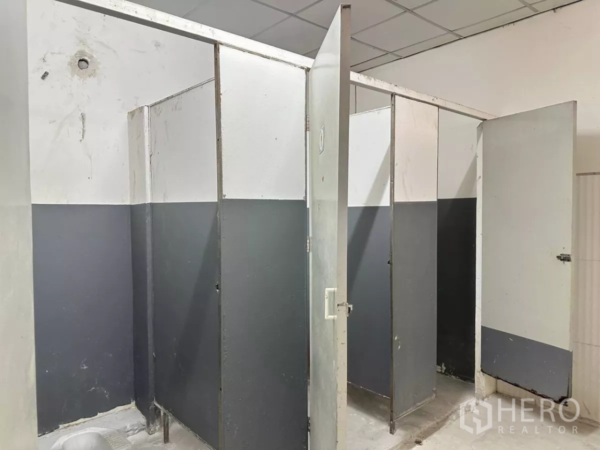 Factory for rent in Samut Prakan - Factory staff restroom area with partitioned stalls.