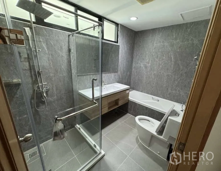 Condominium for rent - Contemporary bathroom with glass shower enclosure, bathtub and floating vanity.