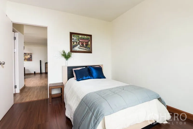 Condominium for rent in Bang Na, Bangkok - Second bedroom interior view toward the hall and living room.