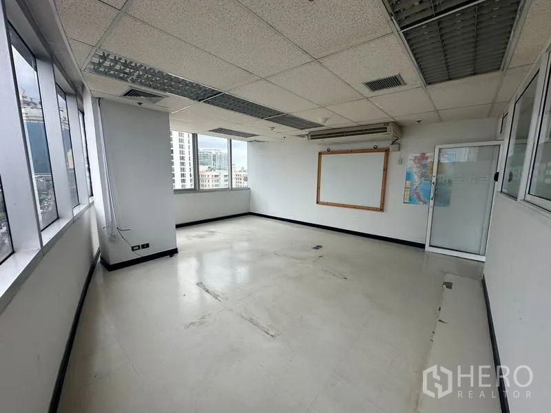 Office Space for rent - Private office room with glass door, corner windows and wall-mounted air-conditioning.