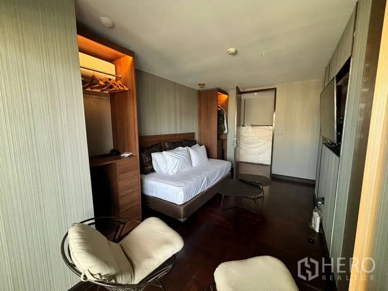 Condominium for rent in Watthana, Bangkok - Alternate view of second bedroom with built-ins and TV.