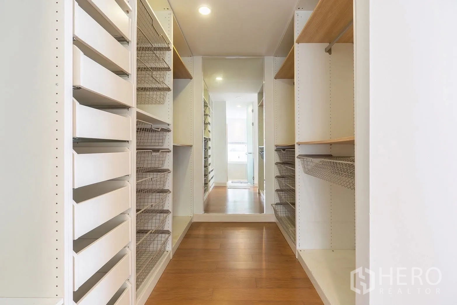 Detached House for rent in Saphan Sung, Bangkok - Walk-in closet corridor with shelves, drawers, and wire baskets.