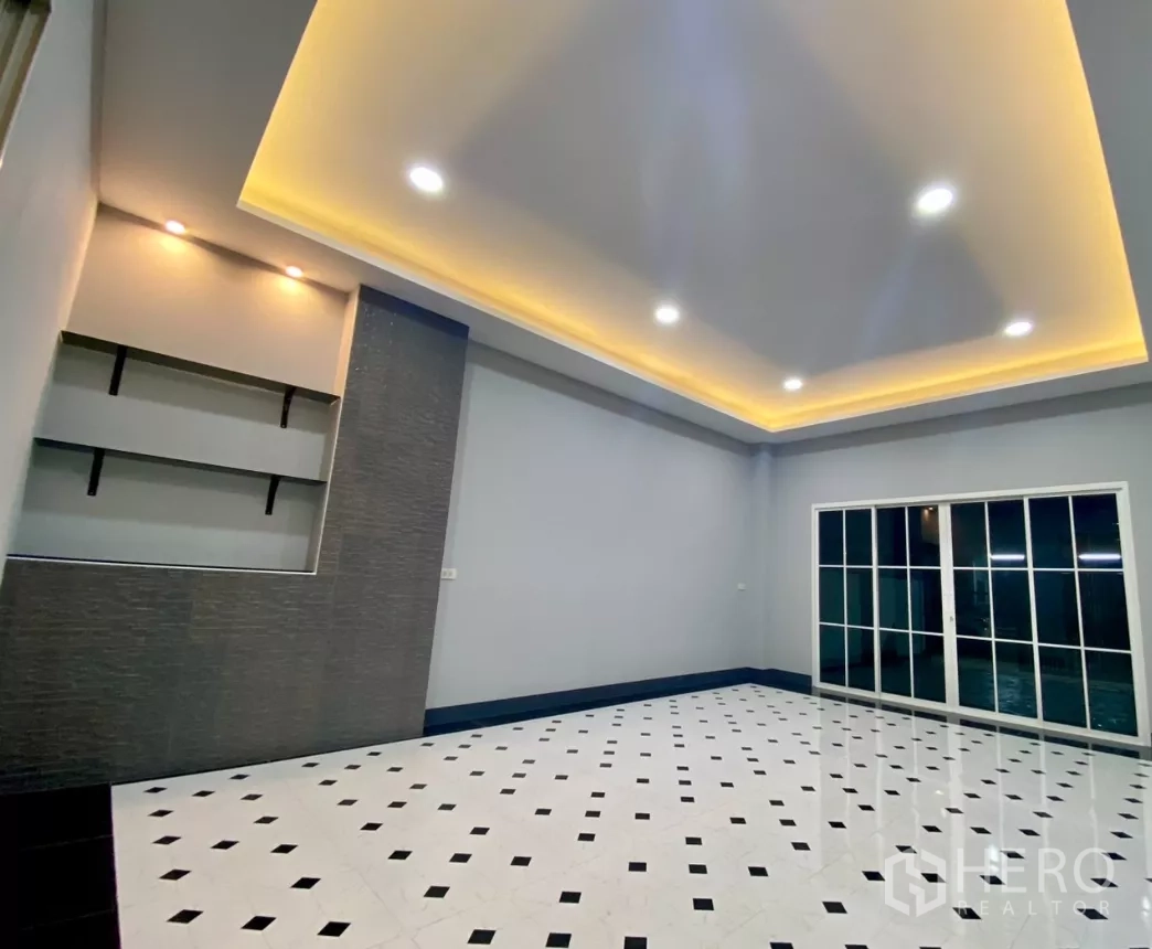 Factory for rent or sale in Bang Bua Thong, Nonthaburi - Open-plan room with feature wall and large front sliding glass doors.