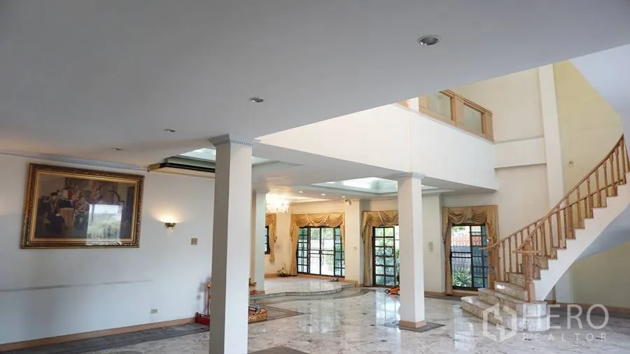 Detached House for sale in Chatuchak, Bangkok - Expansive living hall with double-height ceiling, marble floors and stairway.