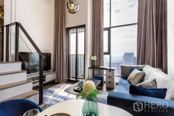 Condominium for rent - Living room facing balcony door and glass-railed staircase with panoramic windows.
