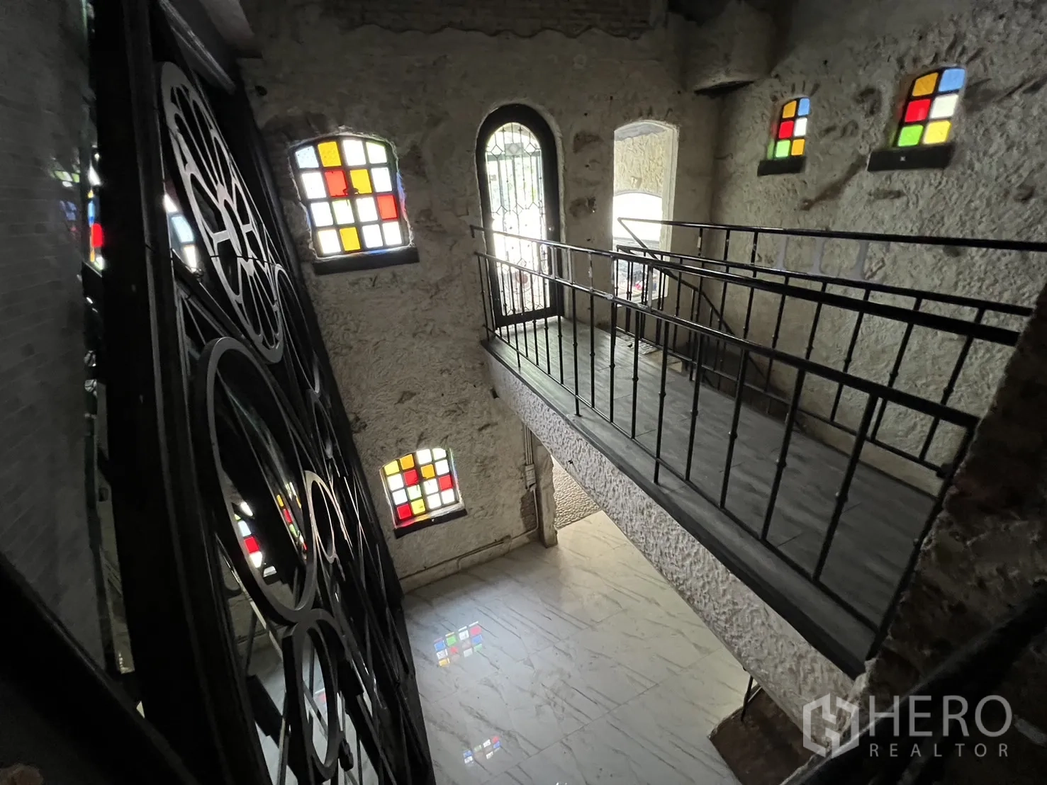 Retail Space for rent in Watthana, Bangkok - Upper gallery bridge beside decorative wrought-iron screen and multiple stained-glass windows.