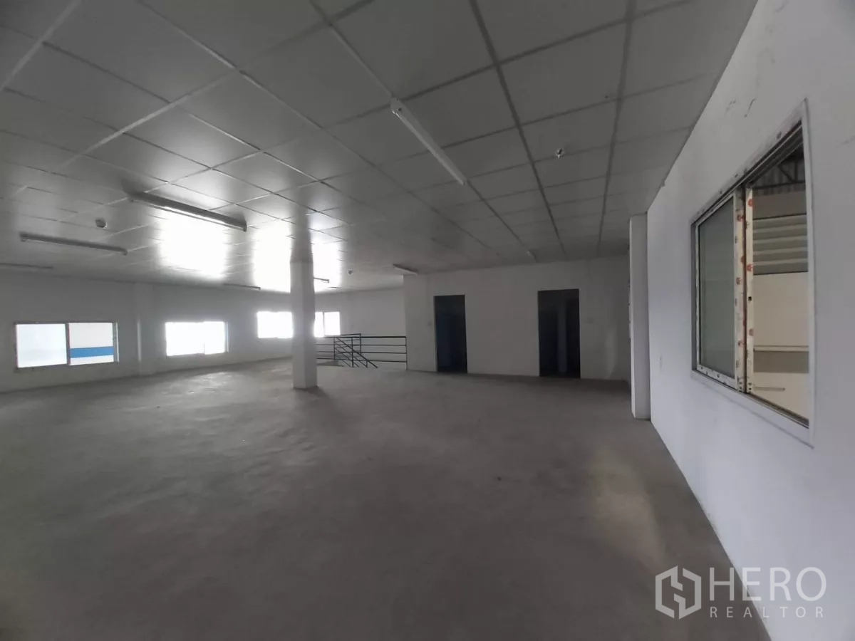 Warehouse for rent in Bang Bo, Samut Prakan - Spacious second-floor office area with windows, drop ceiling and stair access.