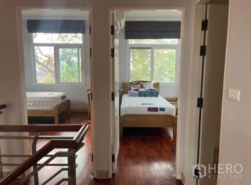 Detached House for rent or sale in Lat Phrao, Bangkok - Upper hallway leading to bedrooms, timber floors and big windows.
