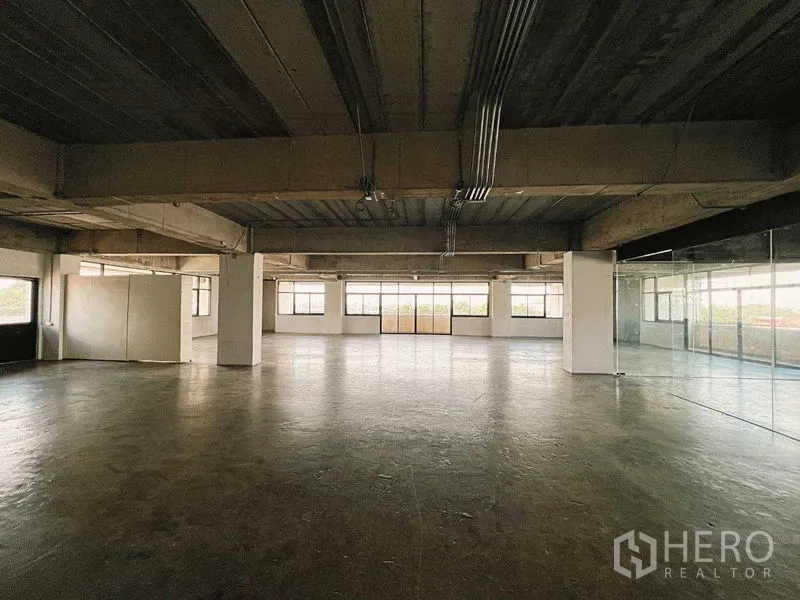 Retail Space for rent in Yan Nawa, Bangkok - Expansive hall with structural beams, glass walls, and panoramic windows.