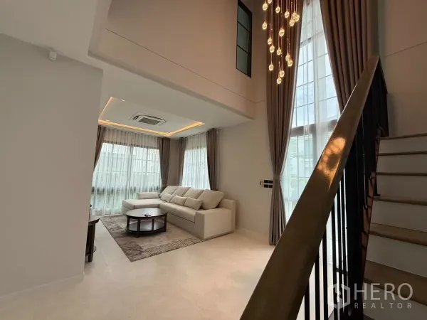 บ้าน ให้เช่าหรือขายในBang Phli, Samut Prakan - โถงรับแขกเพดานสูง Double Volume พร้อมกระจกเต็มบาน โคมไฟระย้า และบันได