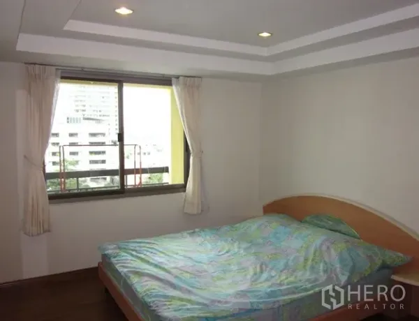Condominium for rent or sale in Watthana, Bangkok - Master bedroom with double bed, window, and skyline views.