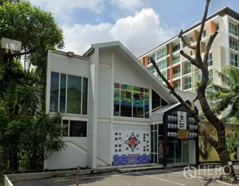Retail Space for rent in Watthana, Bangkok - Front exterior of a two-storey standalone retail building with large windows and on-site parking.