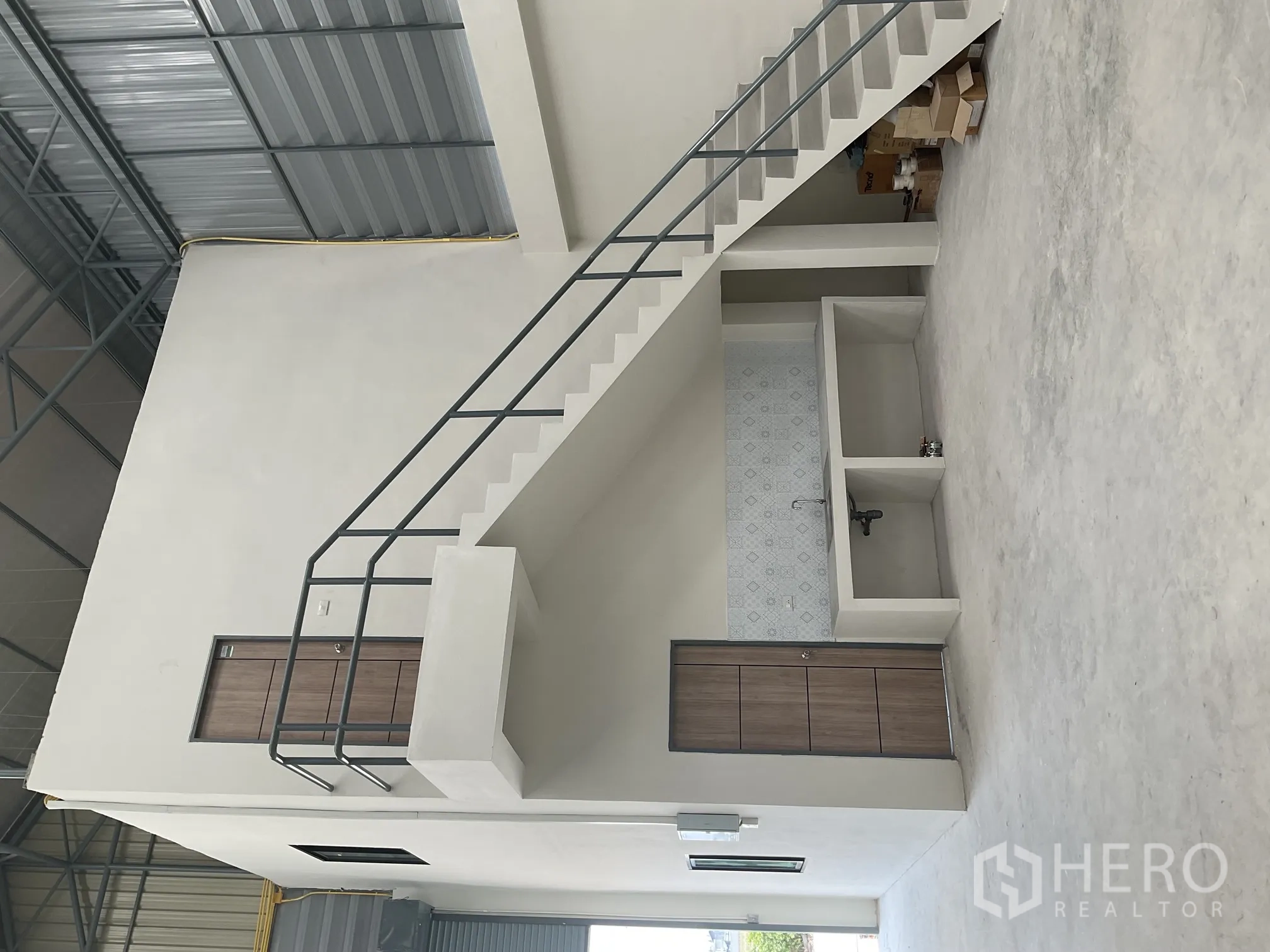 Warehouse for rent in Lat Lum Kaeo, Pathum Thani - Warehouse hall showing staircase to upper office and built-in pantry area.