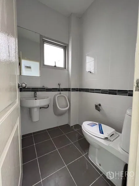 Home Office for sale in Lat Krabang, Bangkok - Street-facing exterior of new white townhouse block with large windows and slatted panels behind a white fence.