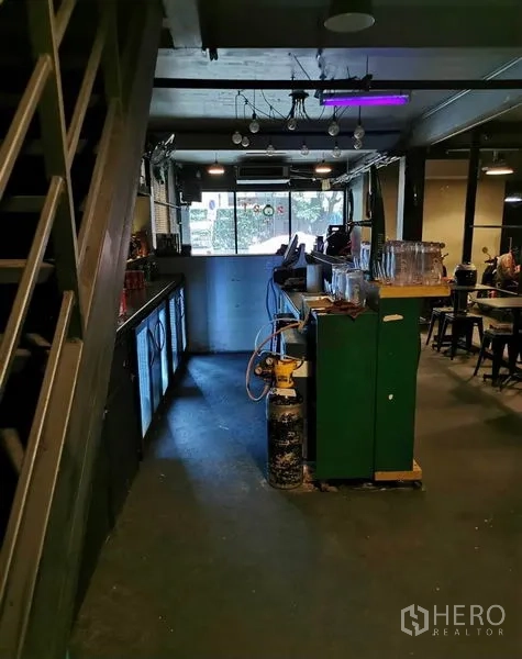 Shophouse for rent or sale in Watthana, Bangkok - Bar service zone beside a metal staircase with refrigerators and equipment.