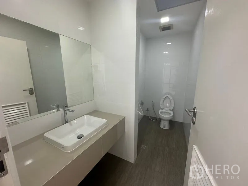 Office Space for rent - In-suite restroom with vanity sink, mirror, and toilet.