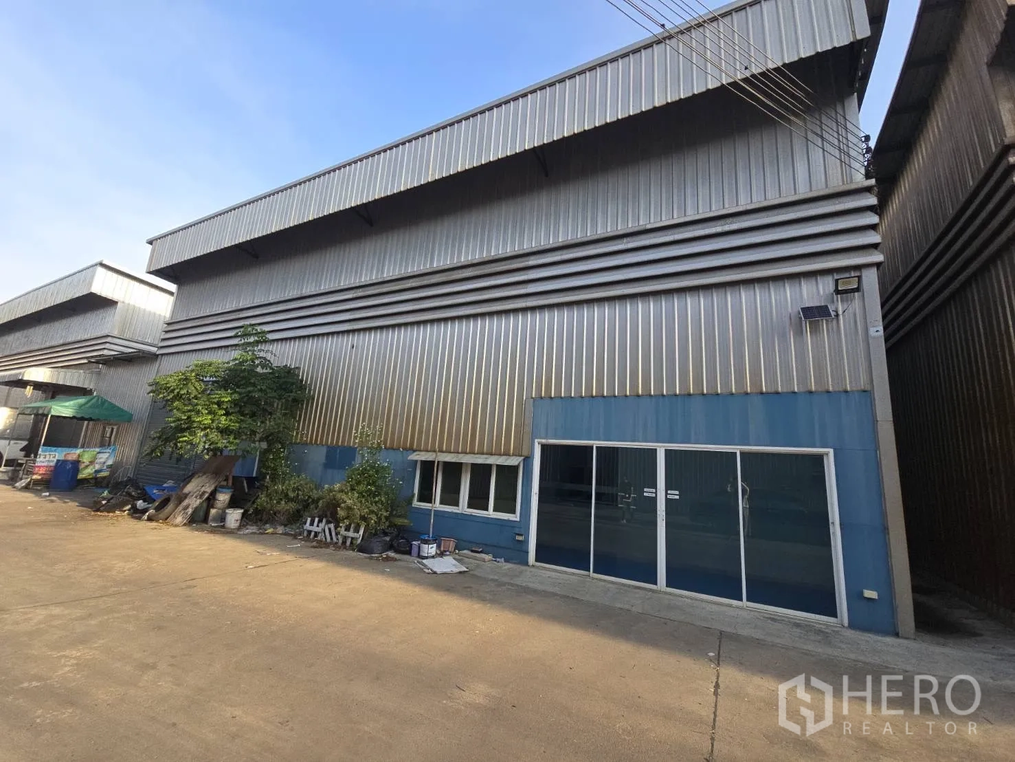 仓库 for rent in Bang Phli, Samut Prakan - 仓库正面立面，带推拉玻璃入口与混凝土车道。