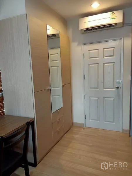 公寓 出租在Bang Rak, Bangkok - 卧室一角，带镜面衣柜、木地板与空调。