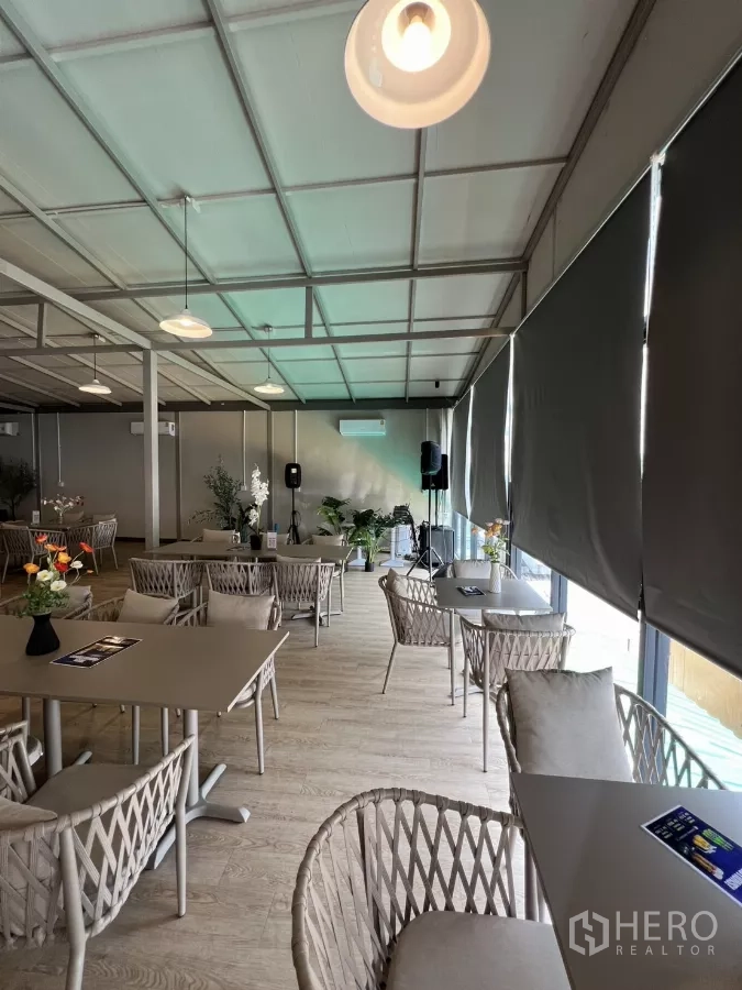 零售空间 出租在Khlong Toei, Bangkok - 狭长活动用餐区，配卷帘、吊灯、浅色木地板与音响设备。