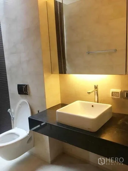 公寓 出租在Bang Rak, Bangkok - 现代卫浴，方形台上盆与背光镜柜。