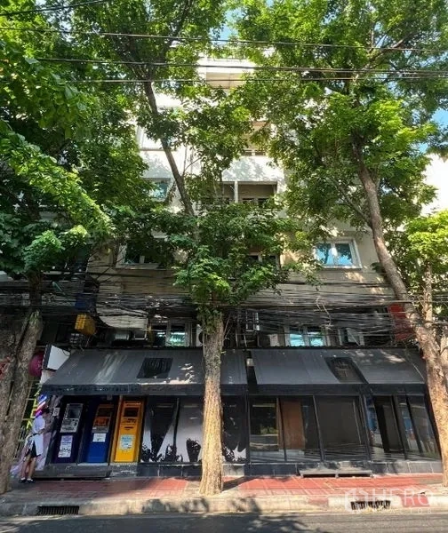 Retail Space for rent in Bang Rak, Bangkok - Shophouse-style façade shaded by mature trees along a city street.