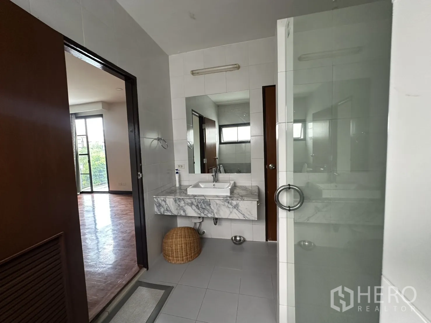 Detached House for rent in Watthana, Bangkok - Bathroom with glass shower, marble sink, and window.