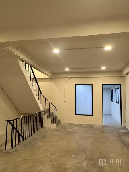 Shophouse for rent - Bright workspace level with staircase, interior windows and a separate office room.