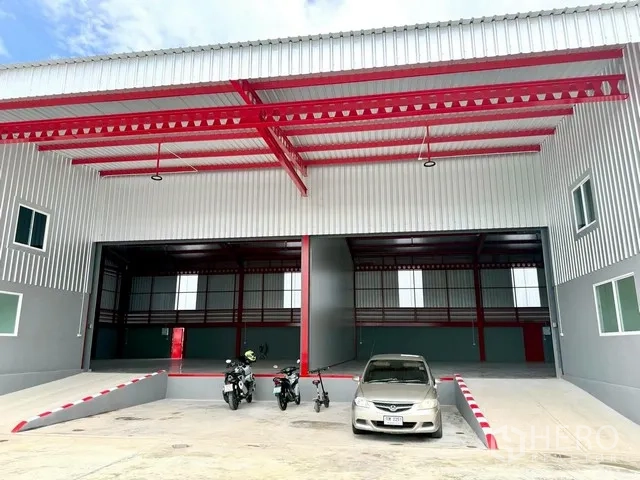 Warehouse for rent in Bang Bo, Samut Prakan - Front view showing twin loading bays with ramps and parking area.