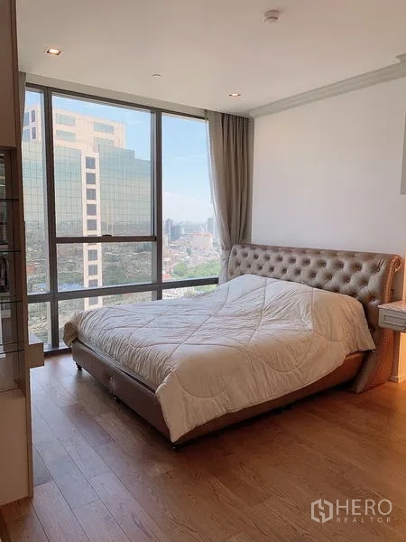 Condominium for sale - Bedroom with floor-to-ceiling corner windows and a king bed.