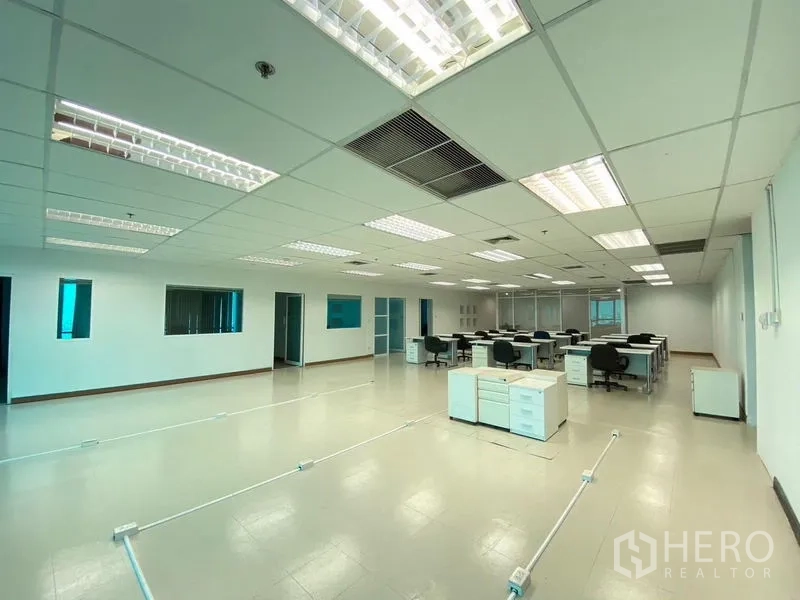 Office Space for rent - Spacious open office area with desks, drawer units and cable floor boxes.