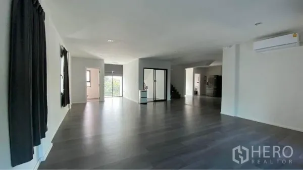 Retail Space for sale in Bang Na, Bangkok - Expansive open‑plan floor with dark wood flooring, glass partitioned room and air conditioning.