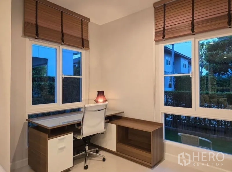 Detached House for rent - Corner home office with L-shaped desk, white task chair and garden views.