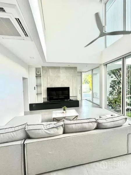 Detached House for rent or sale in Bang Phli, Samut Prakan - Double-height living room with sectional sofa and a TV feature wall.