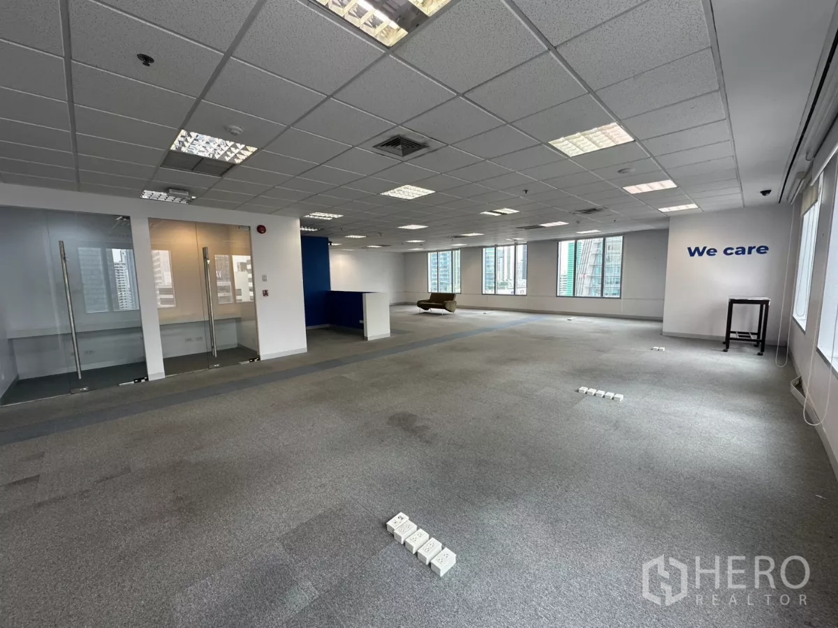 Office Space for rent in Watthana, Bangkok - Open area with natural light, glass rooms and ceiling grid lighting.