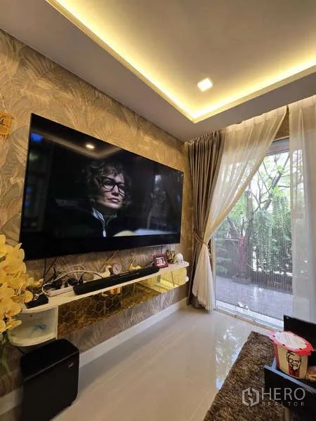Detached House for rent in Thanyaburi, Pathum Thani - Living room with sliding glass door opening to the garden terrace and sheer curtains.