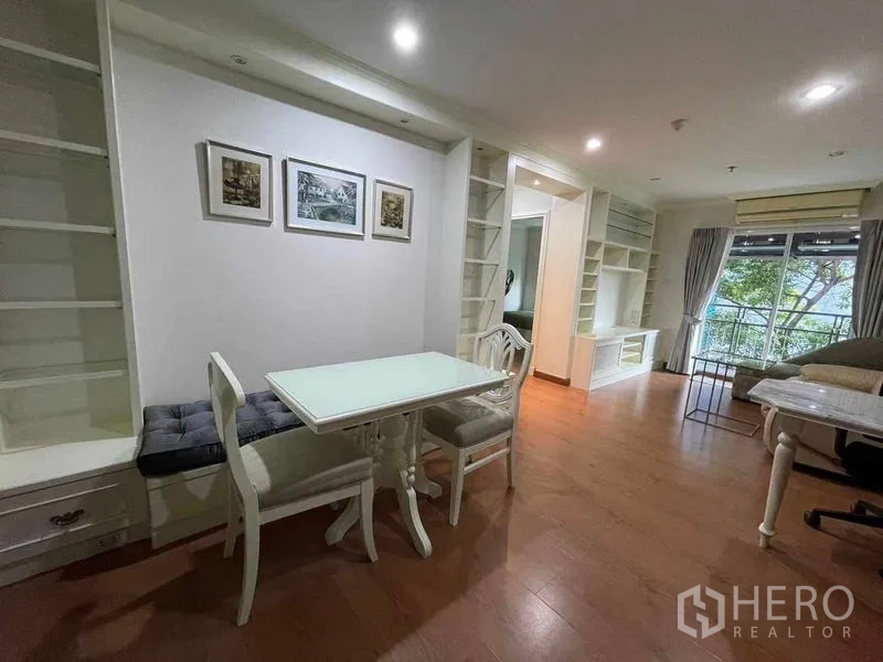 Condominium for rent - Dining area beside built-in shelving connected to living room and balcony.