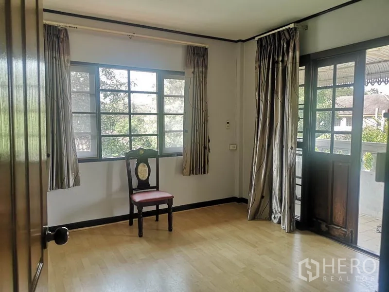 Detached House for sale - Upper-floor room with large windows and a door opening to a covered balcony.