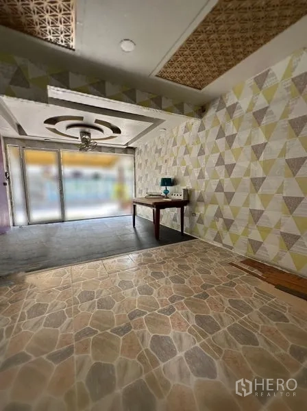Retail Space for rent in Watthana, Bangkok - Compact retail interior with patterned stone-look tiles, feature ceiling light, and full-height glass storefront.