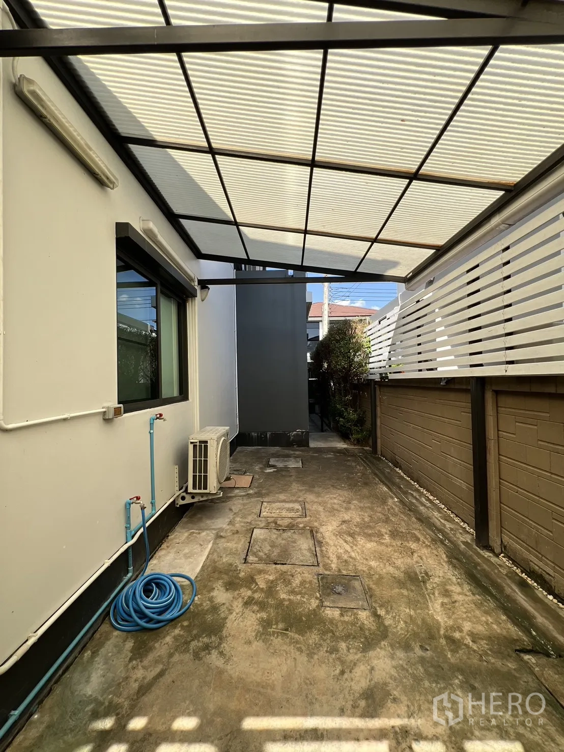 Detached House for sale in Bang Kapi, Bangkok - Rear service area with water tank and polycarbonate roof.